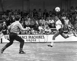 Brian Stein chips the ball over Hans Segers for the first goal scored on the artificial surface