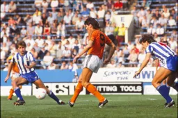 Mick Harford plays the ball forward