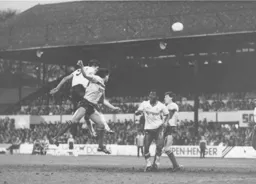 Mick Harford rises highest to head the ball goalwards