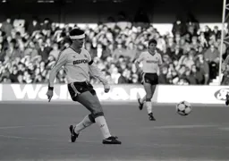 Steve Foster sending a pass through midfield