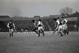 Ricky Hill wriggles past Kenny Sansom