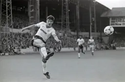 Mick Harford drives in a cross