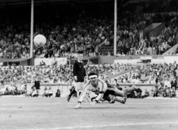 A diving header by Steve Foster clears the ball away