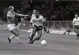 Ricky Hill takes the ball past Ian Wilson