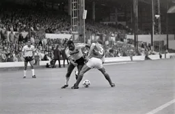 Ricky Hill is poised to nutmeg Kenny Sansom