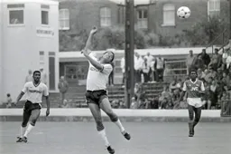 The ball sails over Brian Stein