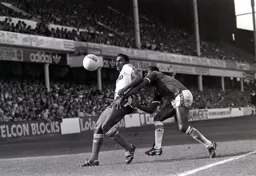 Ricky Hill has George Parris for company as he trys to control the ball