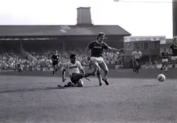 Brian Stein at full stretch as he plays the ball away from Neil Orr