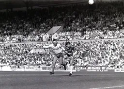 Steve Foster beats Ray Stewart to the ball