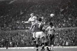Steve Foster wins a header as Ricky Hill searches for the ball