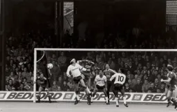 Alan Hansen heads the ball clear from Steve Foster