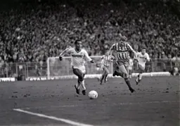 Mark Stein goes on a run with the ball as Nigel Worthington gives chase