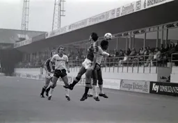 Mark Stein challenges for the ball with Peter Nicholas in support
