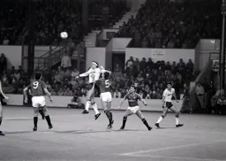 Steve Foster rises above Steve Thompson to meet the ball