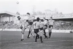 Gary Briggs heads the ball away from Steve Foster