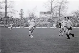 Tim Breacker makes a run into the United penalty area as Dave Langan moves in to close him down