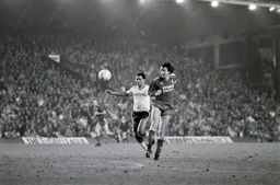 The ball goes past Brian Stein and Alan Hansen