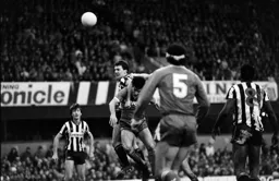 Mick Harford and Peter Jackson challenge for a high ball