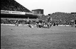 Mick Harford and Peter Jackson chase a loose ball