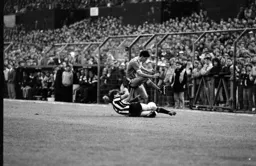Mike Newell rides a sliding tackle