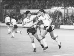 Mike Newell congratulates Mick Harford after scoring Town`s second goal from the penalty spot
