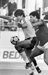 Mick Harford shields the ball from Paul McGrath