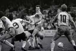 Peter Nicholas and Mike Newell fight to win the ball
