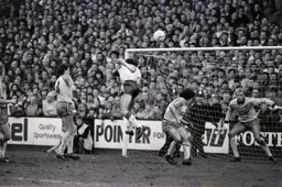 Mike Newell heads the ball towards goal as City keeper Bryan Gunn is poised to make a save