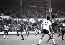 Mick Harford puts his shoulder into the back of Alan Cork
