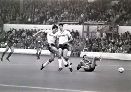 Mick Harford takes a shot at goal as Mike Newell steps out of the way