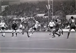 Mike Newell goes to ground under pressure from Vinnie Jones