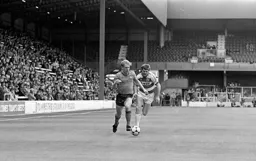 Tim Breacker shows Robbie James a clean pair of heels