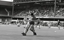 Mike Newell and Robbie James get into a tangle as they compete for the ball