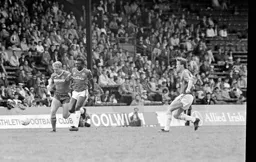 Tim Breacker and Garth Crooks in a race for the ball