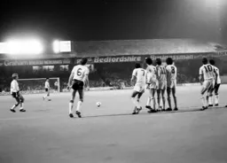 A direct free kick comes in but the United wall stands firm