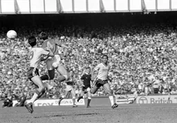 Kevin Ratcliffe heads the ball away from Mike Newell