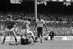 David Preece goes to ground under Kevin Ratcliffe`s challenge as Rick Hill looks on