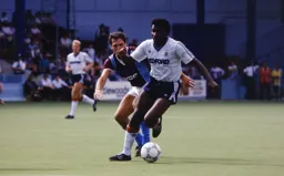 Ricky Hill brushes past Alvin Martin