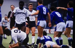 A melee ends with Mick Harford and Dave Watson on the ground