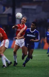 Mark Stein challenges for the ball with Steve Gritt