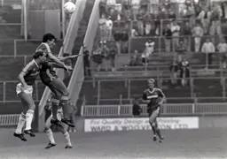 Mick Harford soars over the midfielders