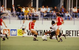 Ricky Hill finds his path blocked by Paul McGrath