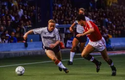Mick Weir takes the ball past Colin Gibson