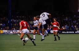 Micky Weir and Mick Harford go for the ball together