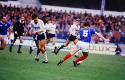 Malcolm Shotton takes the ball away from Mick Harford