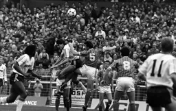 Mick Harford attempts to release Hill
