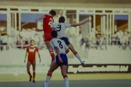 Mick Harford and Gary Gillespie challenge for the ball