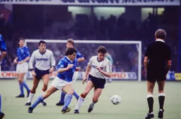 Danny Wilson has to avoid a defender and the referee