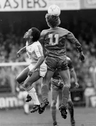 Mark Stein challenges for the ball