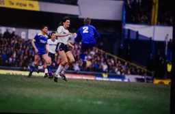 John Scales clears the ball away from Mick Harford